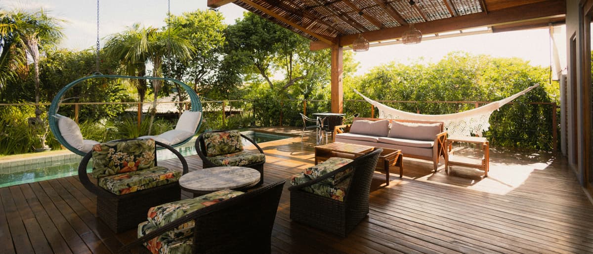 Timber deck and pergola beside a backyard pool, the kind of outdoor space Hogan Projects builds around Flagstone