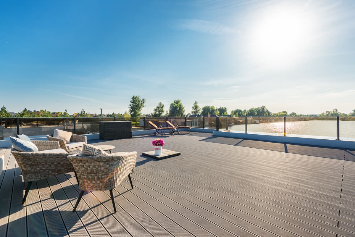 Timber rooftop deck with outdoor seating looking out over the water
