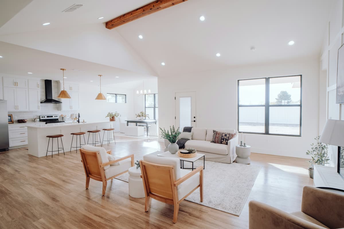 Open-plan living area with timber floors and an exposed beam